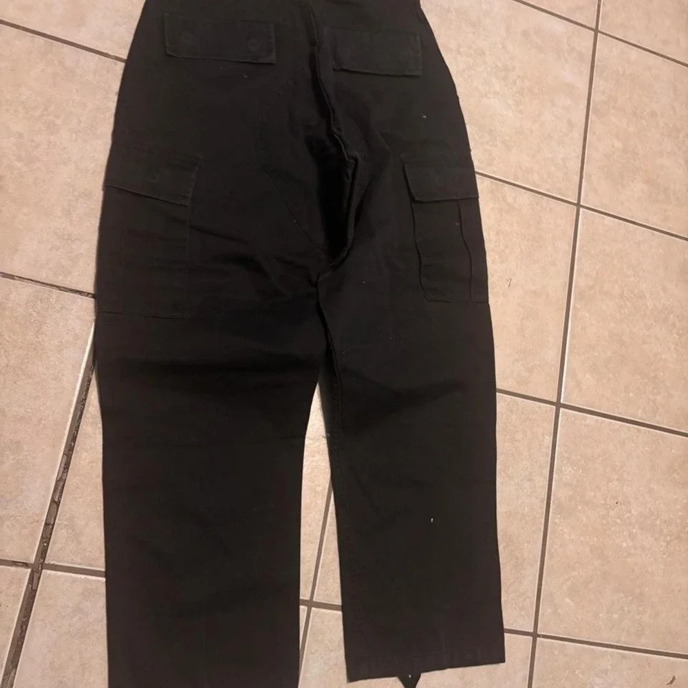 Black vintage cargo pants with adjustable waist and ankle ties